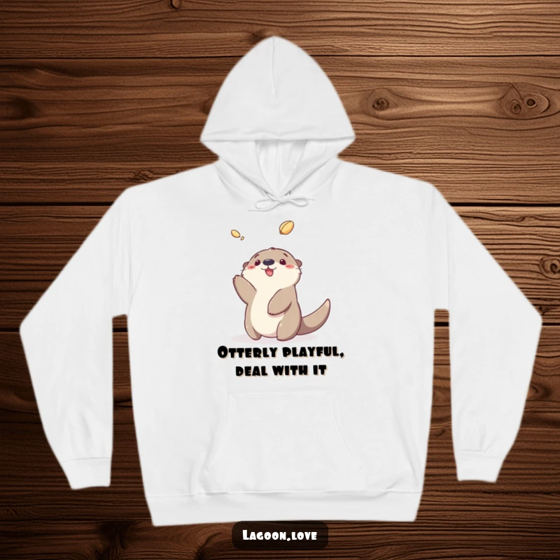 Funny sea otter hoodie featuring a fluffy cartoon otter joyfully tossing a shell, perfect for cozy days.