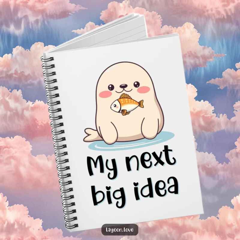 Funny notebook: a plump, round seal balancing a tiny, brightly colored fish on its nose.